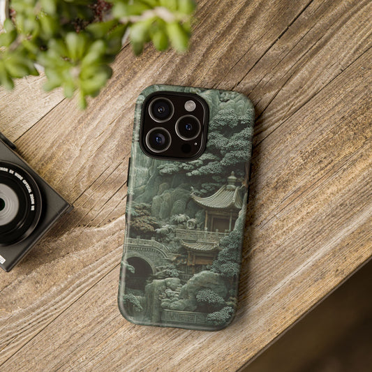 green jade temple iPhone case on wooden table with plant decor, showcasing intricate Chinese landscape design in natural light